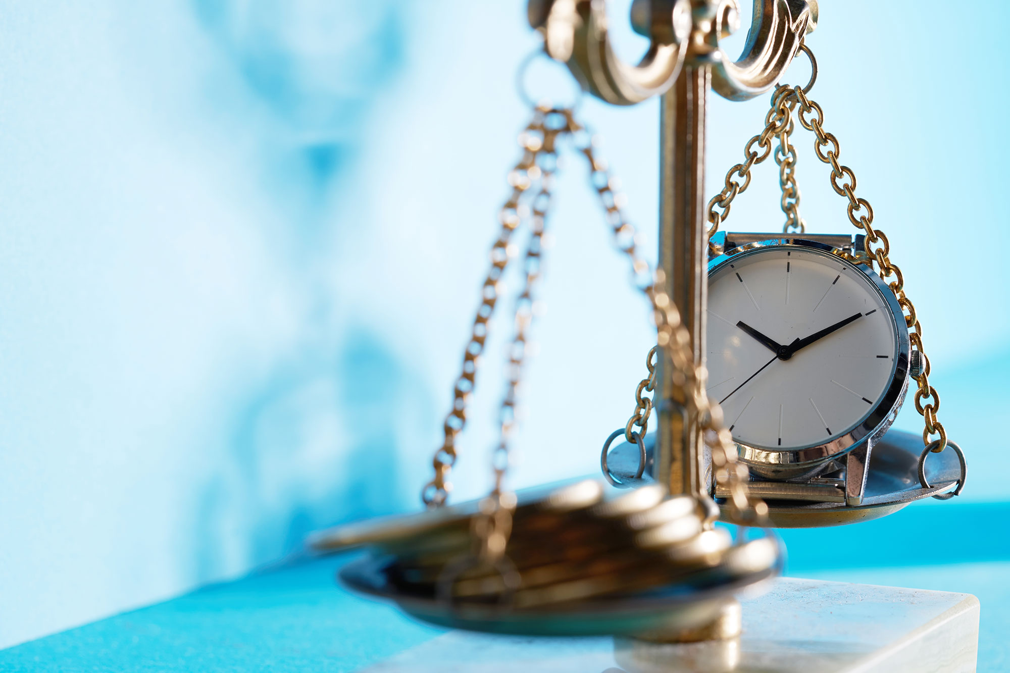 scales of justice with money on one side and clock on the other